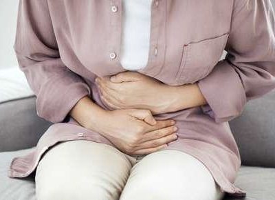 woman holding her stomach due to pain